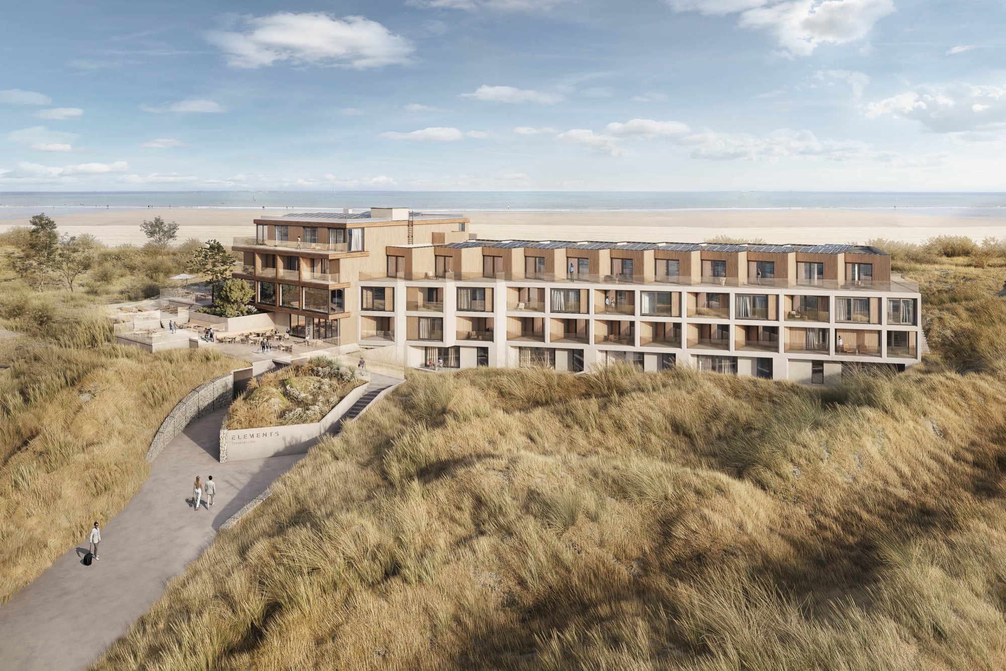 Luchtfoto van Elements Terschelling, een luxe hotel en appartementencomplex midden in het duingebied, met uitzicht op het strand en de Noordzee.