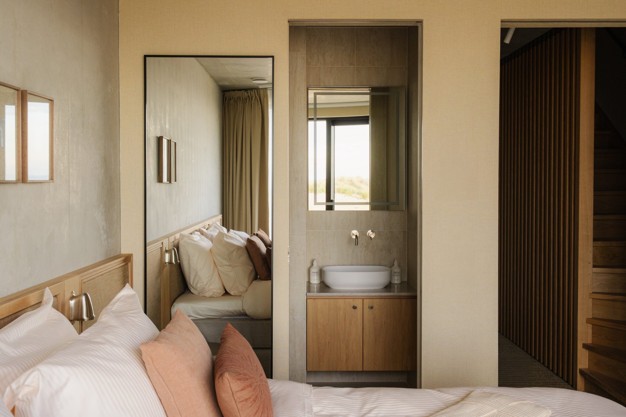 Slaapkamer met doorgang naar badkamer in duplex appartement Elements.